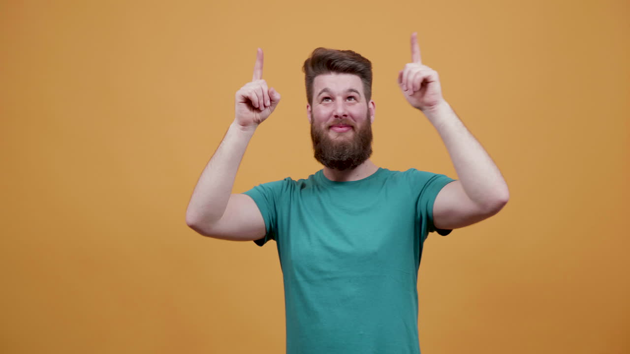 Man with beard pointing up