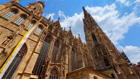 vienna, austria - june 9, 2025: st. stephen's cathedral, vienna. tourists admire the intricate details of st. stephen's cathedral in vienna under a bright blue sky