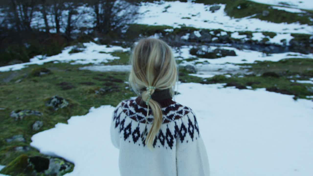 Woman Walking in Snowy Mountain Landscape