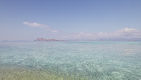 Aerial-Flying-Over-Shallow-Sea-Water-of-Deserted-White-Sand-Komodo-Island-Daytime