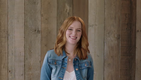 young stylish red head woman portrait of beautiful girl laughing cheerful at camera wearing denim jacket wooden background