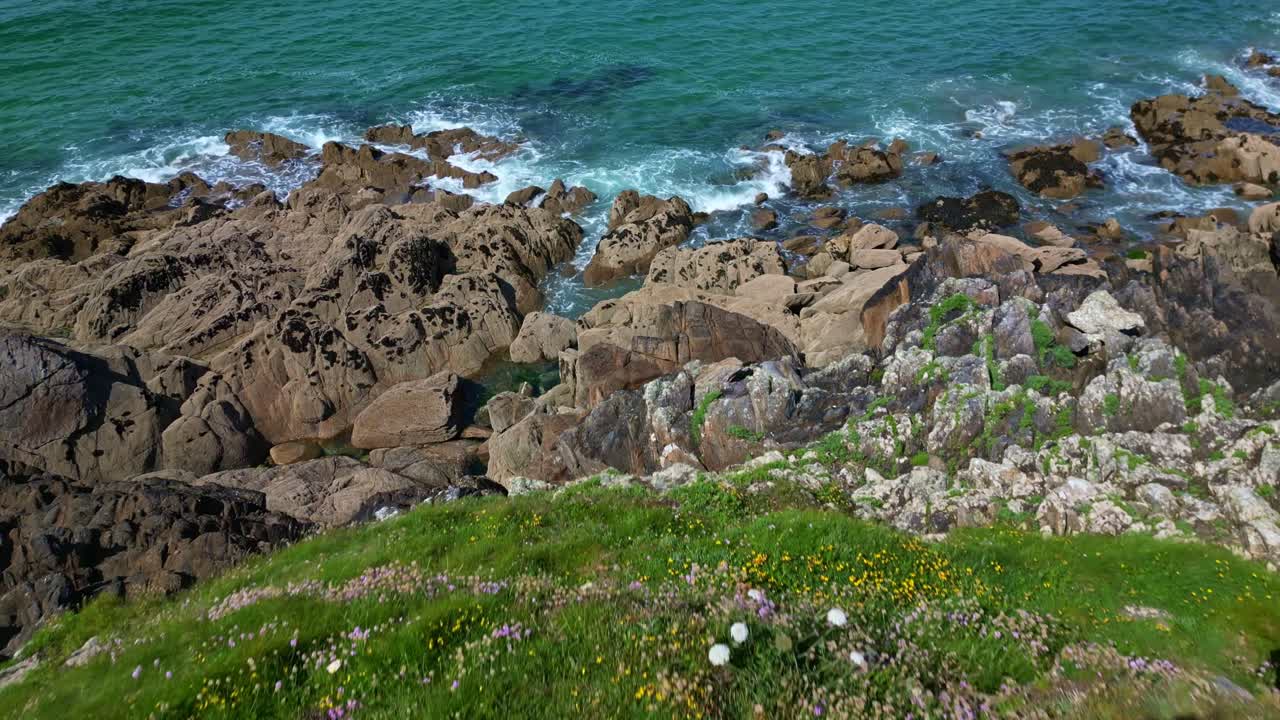 Rocky and wild coast of Brittany. Aerial drone backward