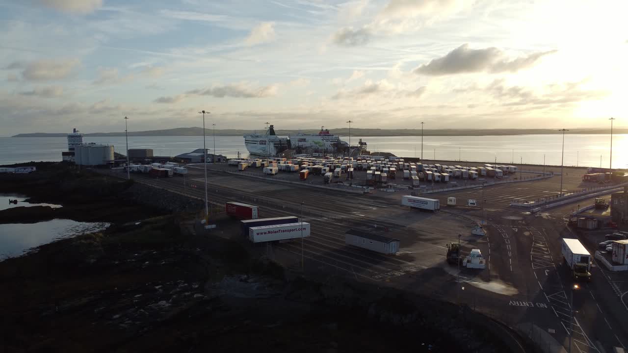 Stena line Holyhead ferry terminal aerial view establishing container trucks parking at sunrise