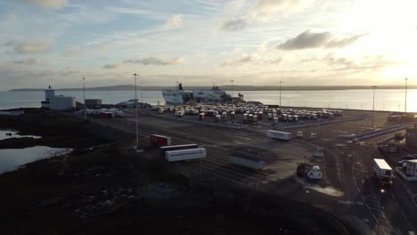 stena line holyhead ferry terminal aerial view establishing container trucks parking at sunrise