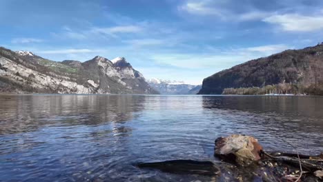 Clear-lake-water,-mountains-in-the-spring,-snow-on-the-peak,-nature