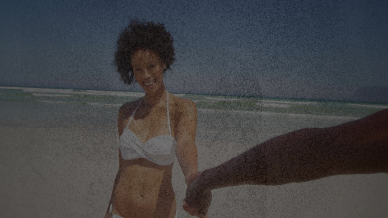 Holding hand on sandy beach, woman smiling in white bikini with animation