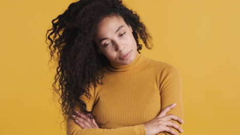 African-american-smiling-woman-over-orange-background.