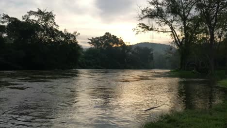 Morning-Sunrise,-River-Overflowing-with-Scenic-Background,-Thailand