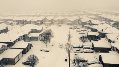 car driving through houses in toronto battered by winter storm blizzard with snow piling up in canada