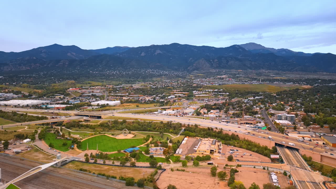 Colorado Springs, USA, 22 July 2025: Green panorama of low-rise Colorado-Springs, Colorado, USA. Mountain range at backdrop
