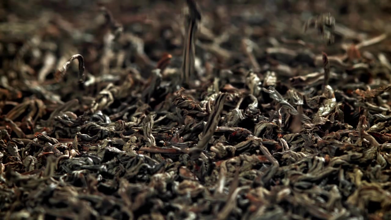 Dried Black Tea Leaves Falling in Slow Motion Close Up