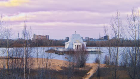 abandoned building on a lake at sunset