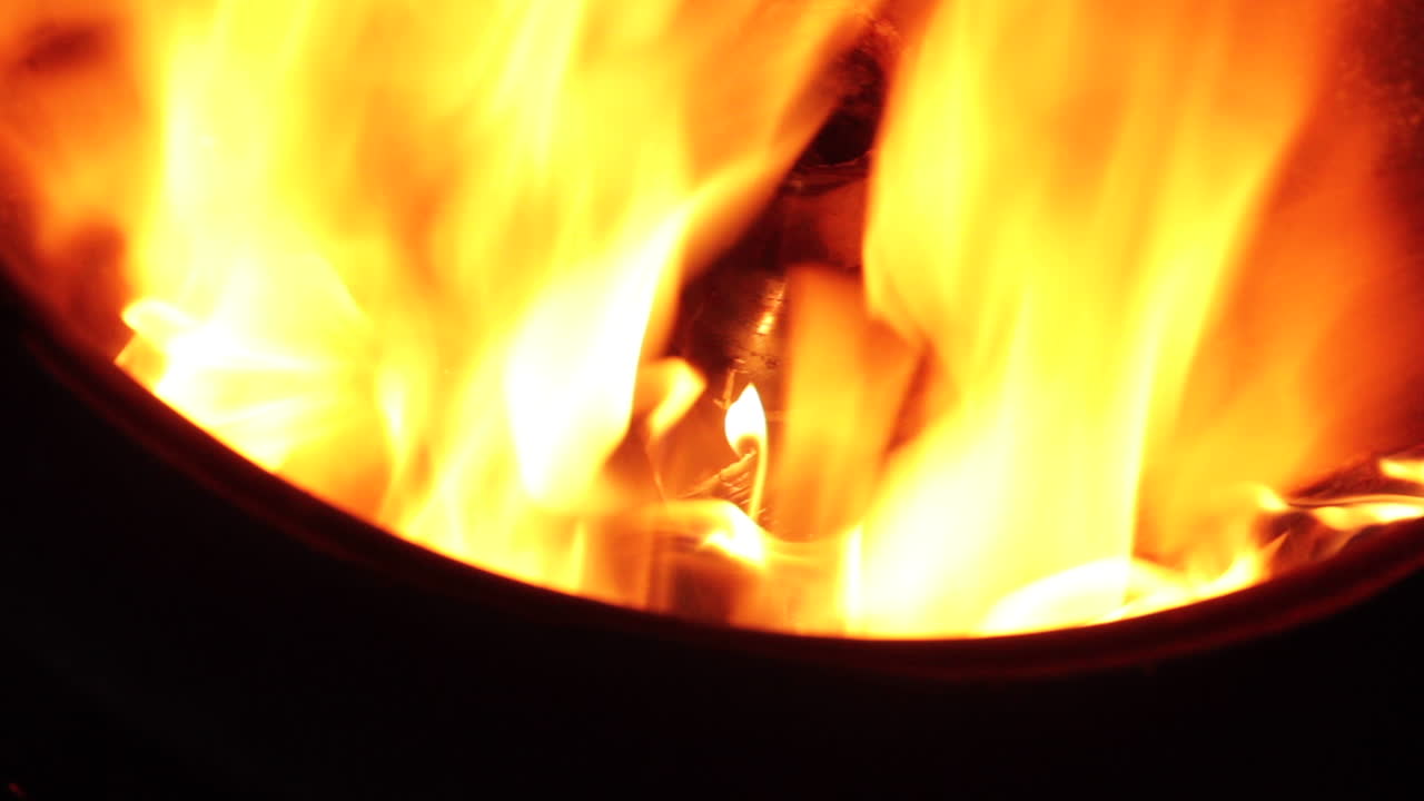 Close-Up of Intense Burning Flames in a Metal Container