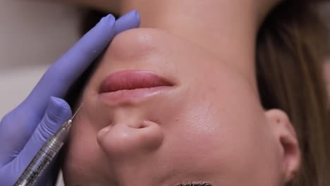 woman receiving lip filler injection
