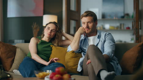 relaxed pair watching movie at evening home. family spending enjoying together