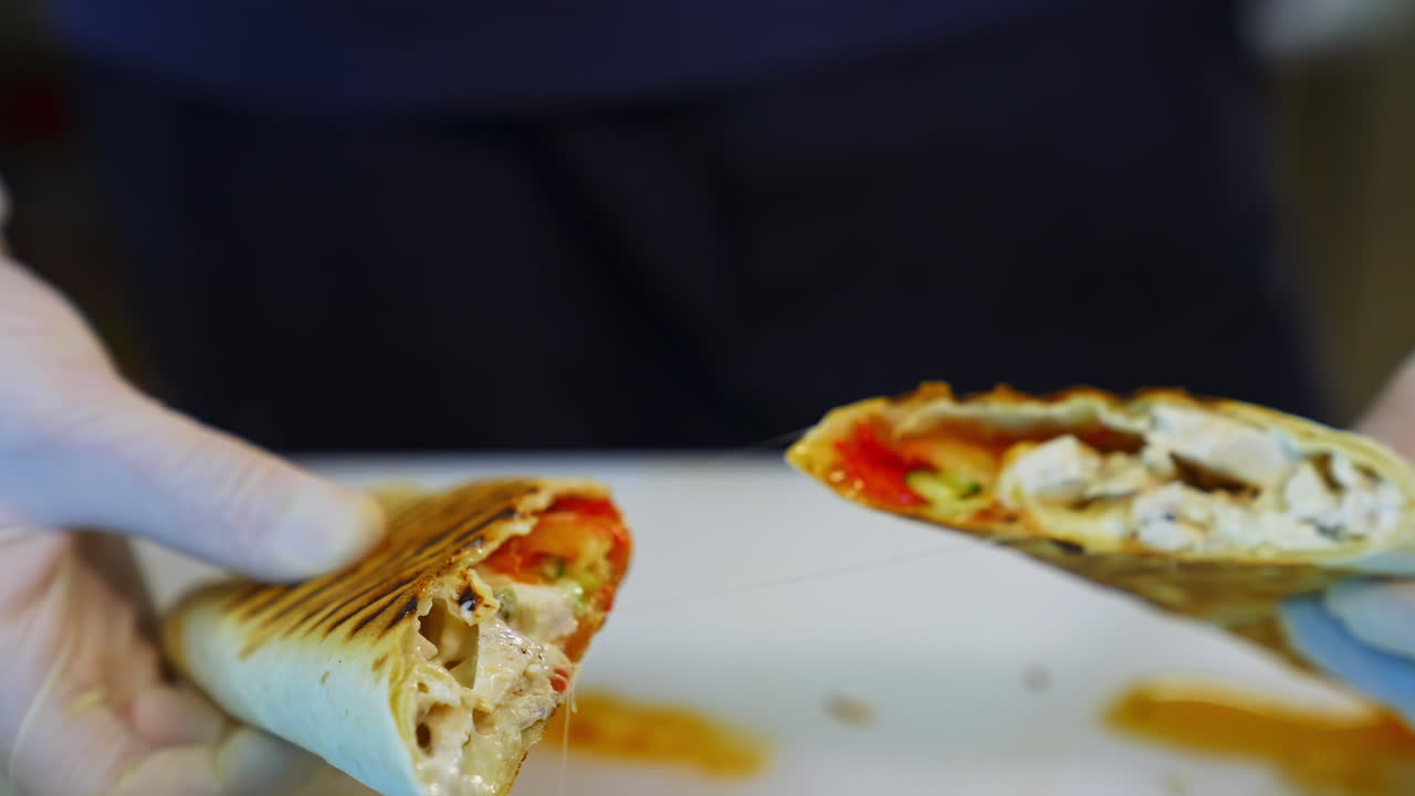 Ready pita with cheese and meat. Chef cutting cooked bakery and shows it filling. Delicious snack in a restaurant. Close-up.