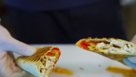 ready pita with cheese and meat. chef cutting cooked bakery and shows it filling. delicious snack in a restaurant. close-up.