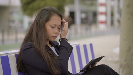 focused young woman using digital tablet