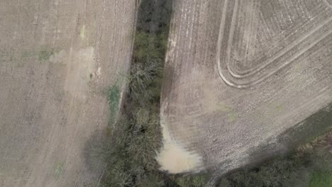 Muddy-ploughed-fields-in-winter-overhead-aerial