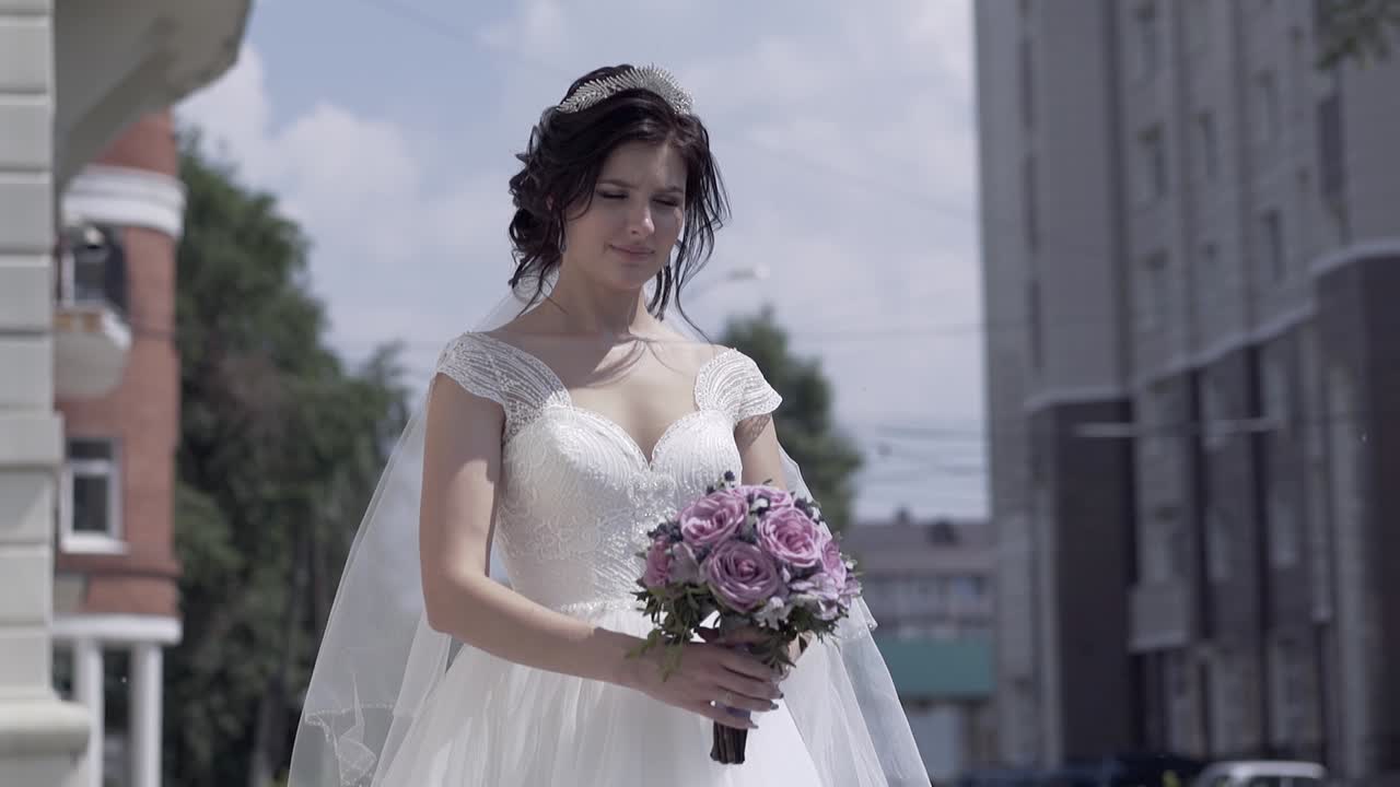 slow motion giovane bella donna tiene un bouquet di nozze viola