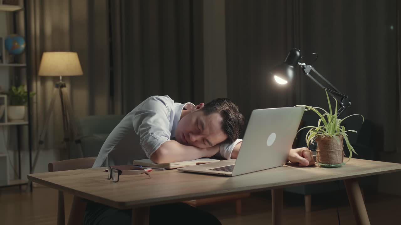 Tired Worker Napping at Desk