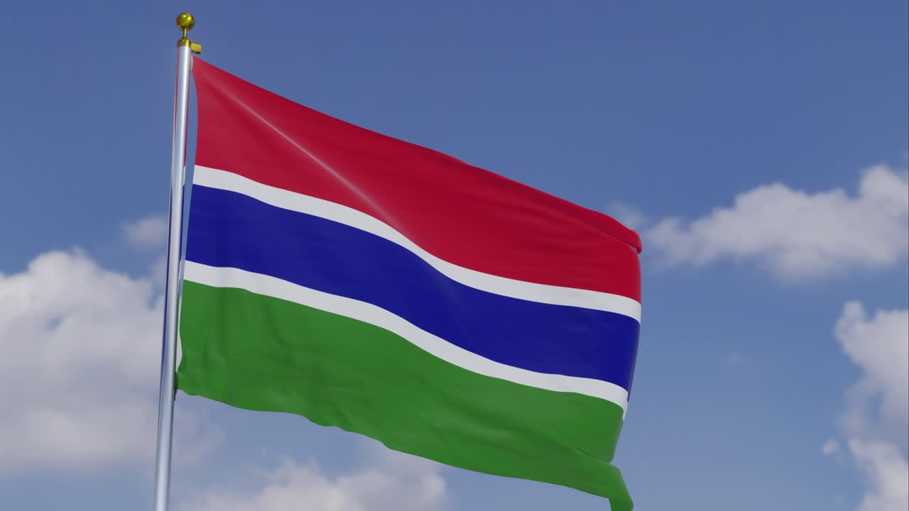 Flag Of Gambia Moving In The Wind With A Clear Blue Sky In The Background, Clouds Slowly Moving, Flagpole, Slow Motion