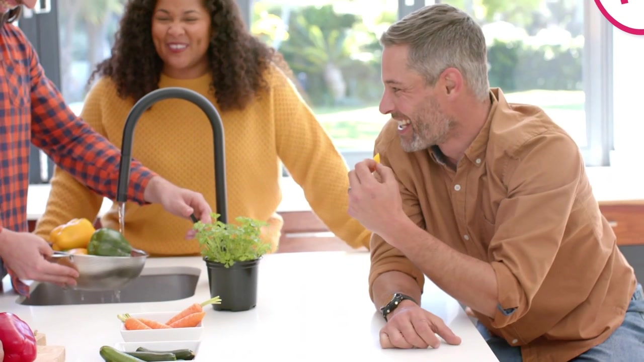 Vertical video: Reaching brown-shirt man sampling at counter as pal passing peppers, tags appearing