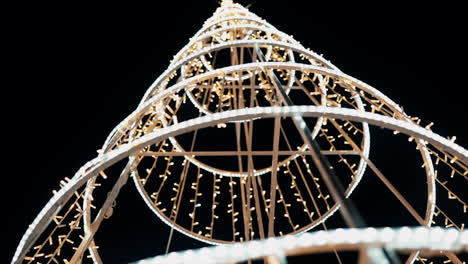 Lit-up-Christmas-tree-structure-at-night