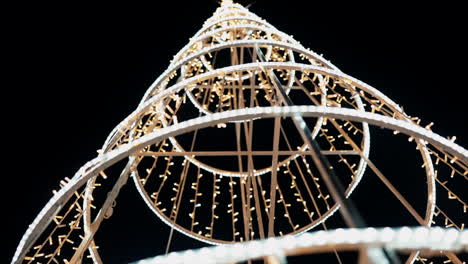 lit-up christmas tree structure at night