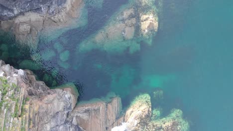 aerial drone view of cornish coast, showcasing blue waters