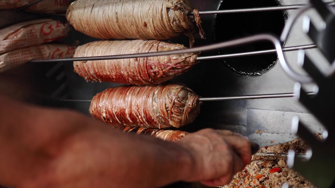 Grigliatura e affettatura del Kokoreç tradizionale turco