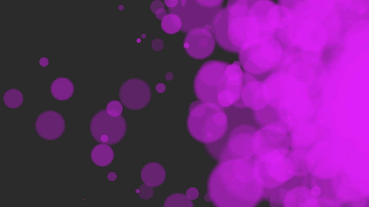 Scintillii e particelle viola su sfondo nero