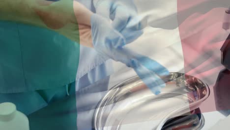 Animation-of-flag-of-italy-waving-over-surgeon-in-operating-theatre