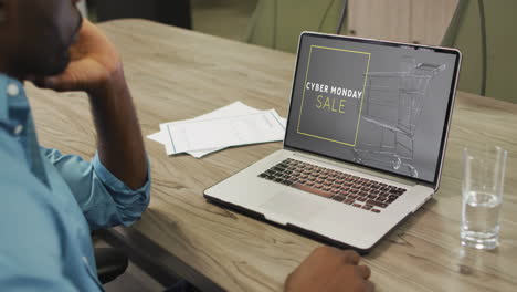 hombre afroamericano usando una computadora portátil, compras en línea en el día de ventas de cyber monday, cámara lenta