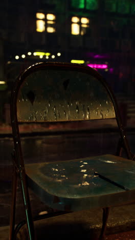 lonely wet chair on a rainy city night