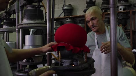 Mixed-race-man-working-at-a-hat-factory