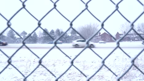 Cars-driving-on-snow-covered-road