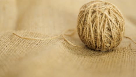 reveal shot of a ball of jute, a hessian and burlap type of natural fibre textile