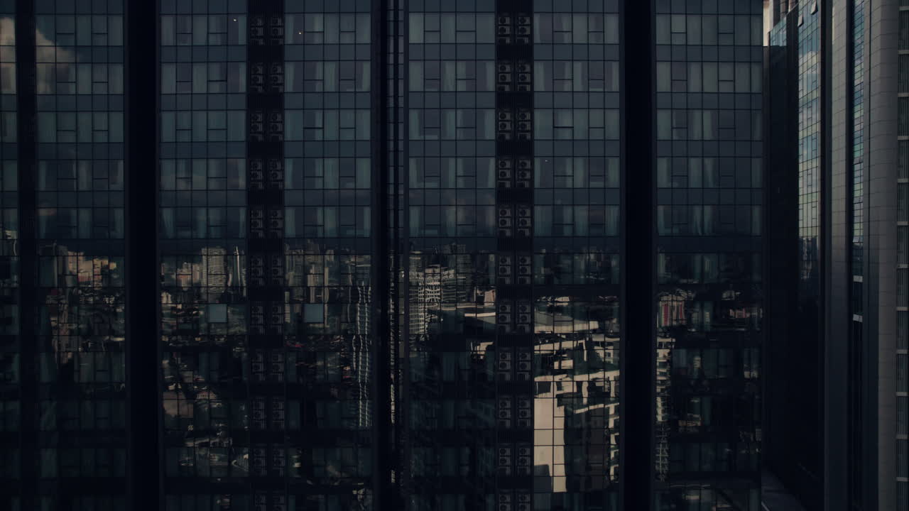 Skyscraper office glass exterior revealing sunrise sky light, Aerial closeup
