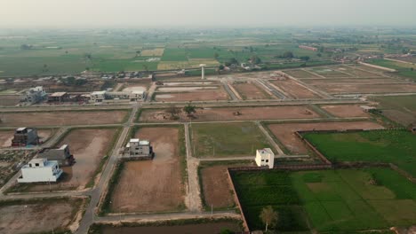 aerial view agriculture land and modern housing society in pakistan