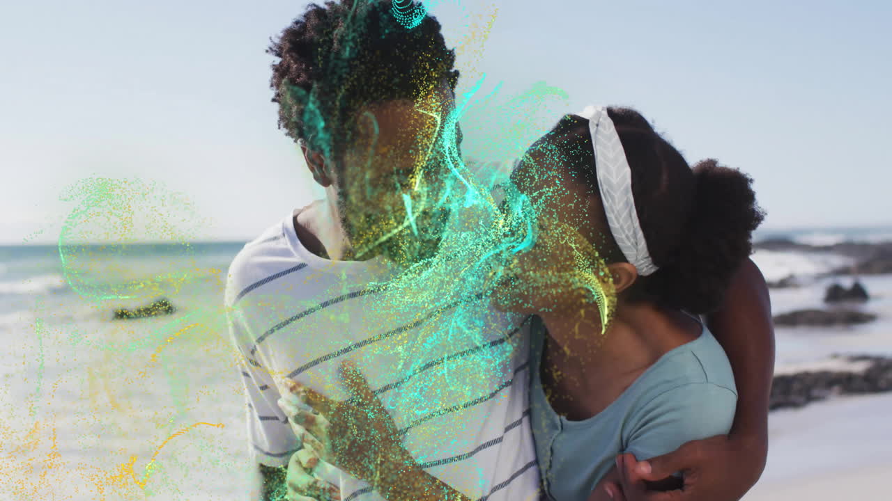 man and woman sharing embrace on sandy beach, swirling digital particles showcasing technology