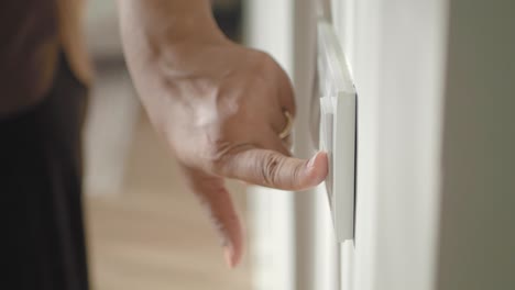 person turning on a light switch