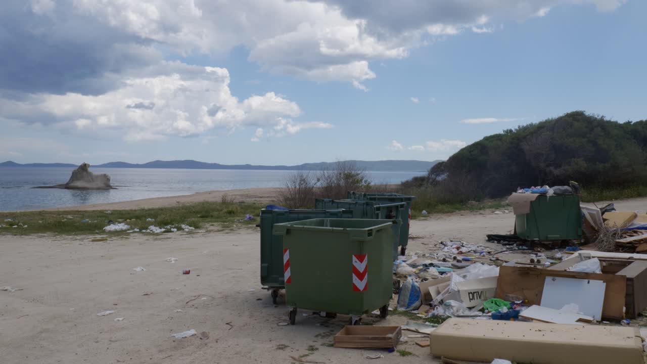 Trash and garbage by a sea beach on a windy day in Greece