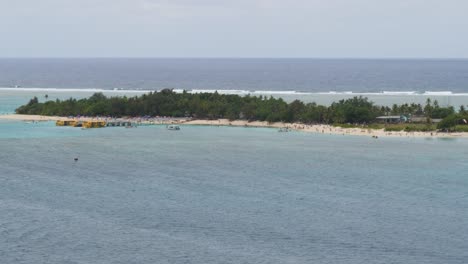 tourists enjoying a day at the beach on mystery island,vanuatu.