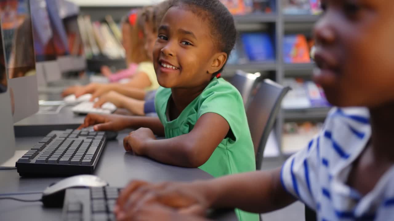 Side view of mixed-race schoolkids studying on computer in the classroom 4k