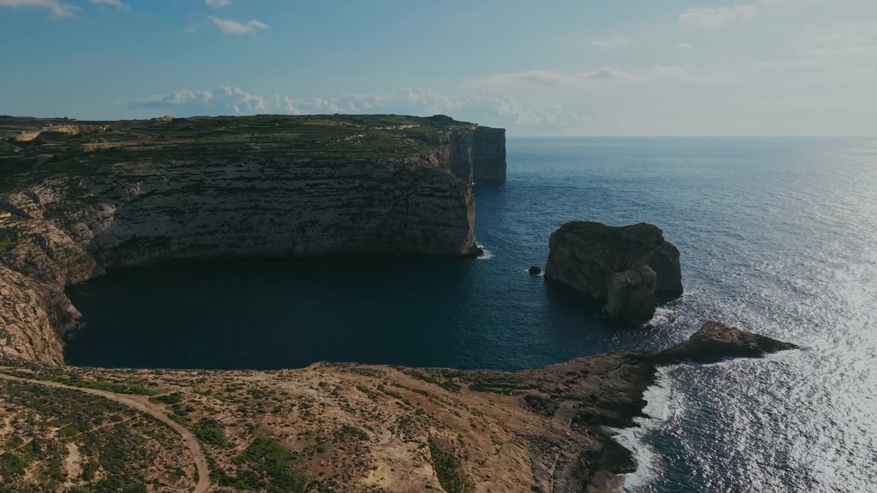 Aerial View of Majestic Coastal Cliffs, Bay, and Watchtower