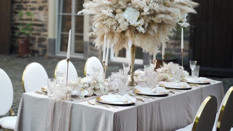 showaround golden white luxury fine art wedding decoration of the bridel desk for dinner with pampas grass