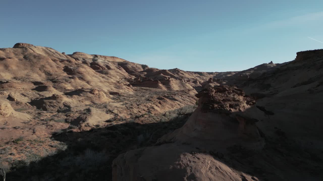 Drone flight reveal remote barren rocky Utah landscape in sunlight
