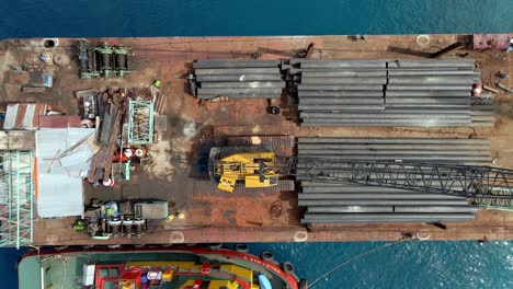 ascening aerial top down of metal pipes on ferry ship during sunny day in asia