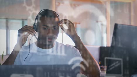 animation of african american putting on headphones on over data processing and forms